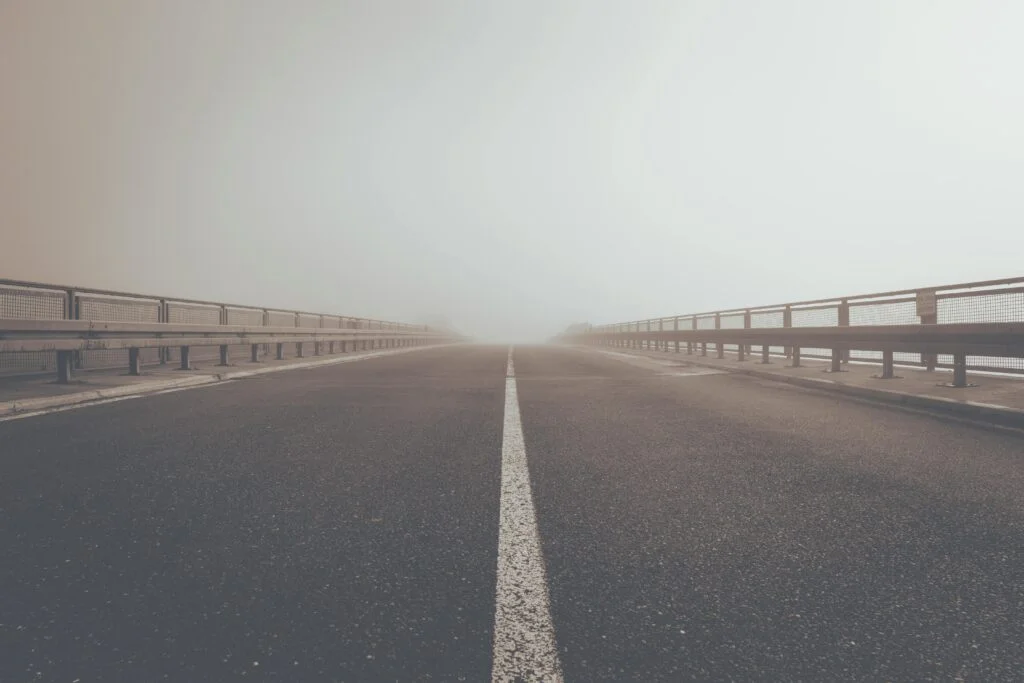 A misty road creating an atmospheric perspective and moody ambiance.